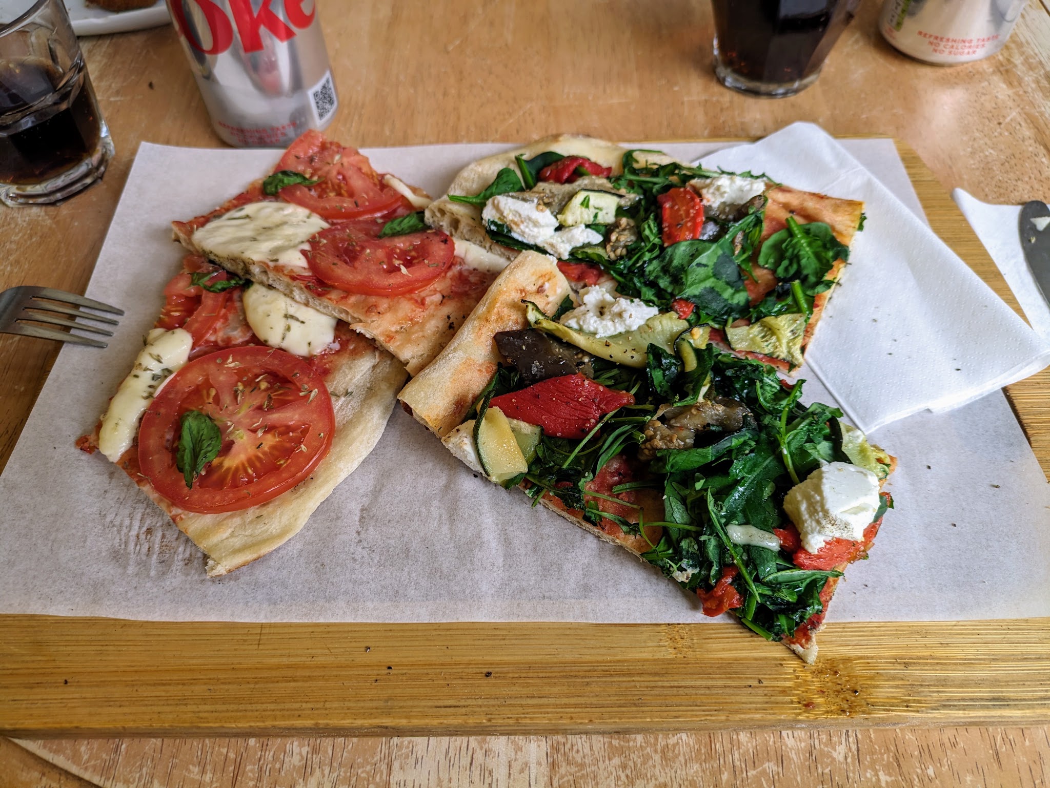 Freshly topped pizza slices served on a wooden table