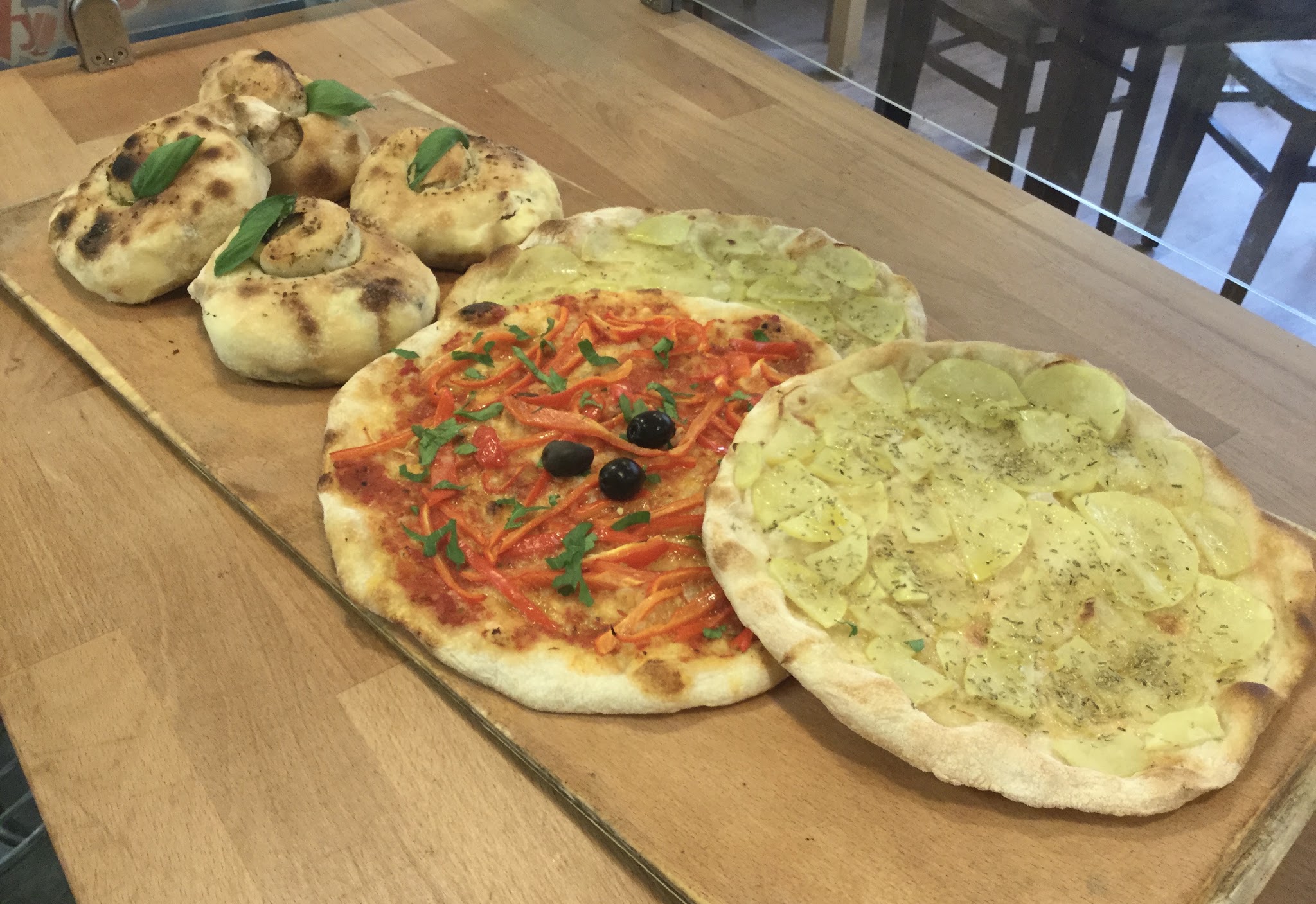 A selection of Italian food displayed on wooden boards